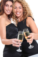 Girlfriends cheering with glasses of champagne
