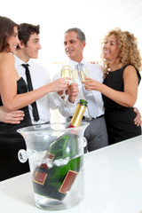 Group of friends cheering with glasses of champagne