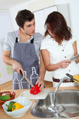 Couple cooking with electronic tab