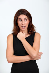 Fototapeta premium Woman in black dress with surprised look