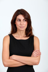 Fototapeta premium Woman in black dress with arms crossed