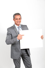 Smiling businessman showing whiteboard