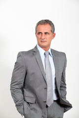 Smiling businessman standing on white background