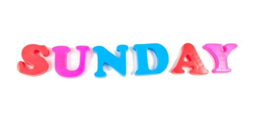 sunday written with fridge magnets on white background