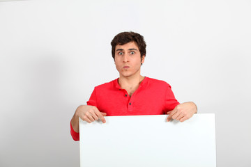 Portrait of young man holding whiteboard