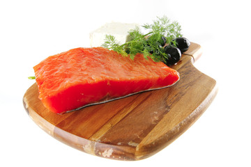 pink salmon on wooden plate with cheese