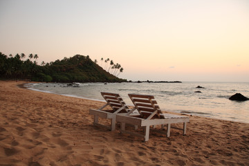 Sunbeds on the beach at sunset