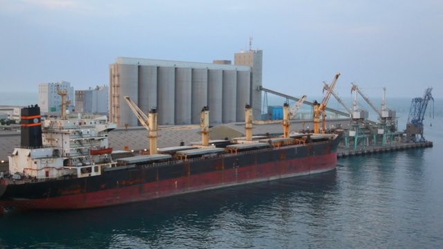 camera moving past by barge stopped in seaport in Abu Dhabi