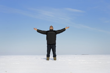 adult man in winter landscape looking up