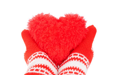 woman hands in red mittens tenderly keeping red heart