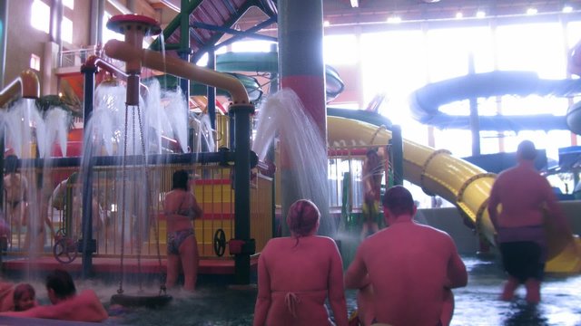 The family has a rest and has good time in aquapark