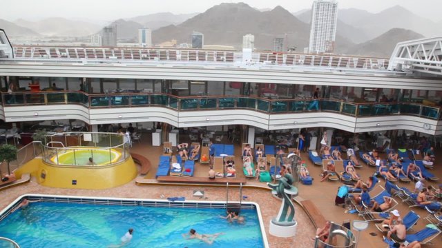 People on upper deck on  newest cruise ship in port