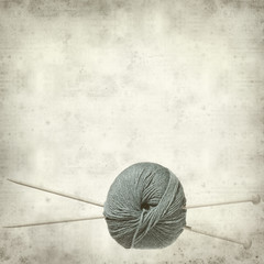 textured old paper background with pair of knitting needles and