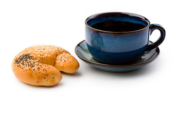 Mug and bun isolated on white