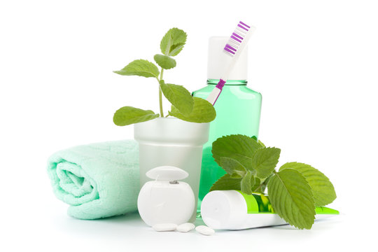 Toothbrush with toothpaste and fresh leaves of mint