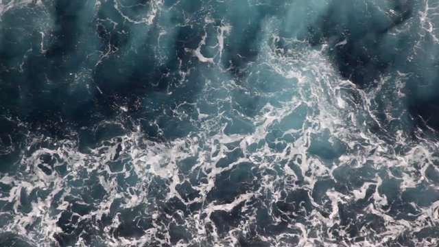 water with foam of sea, top view from moving ship