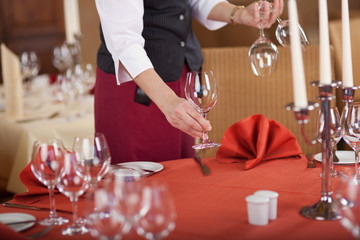kellnerin deckt den festlichen tisch