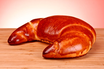 Tasty bagels on a wooden stand with red background