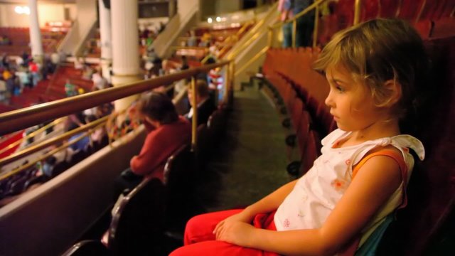 sad girl sits in circus before performance