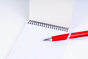 A red pen on a notebook, isolated in white background.