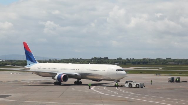 Service vehicle is pulling plane in London.