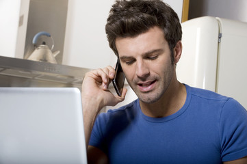 man in the kitchen with laptop