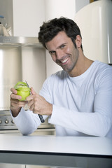 Fototapeta premium man peeling an apple