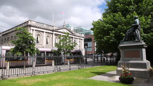 Tram passes near monument in city center