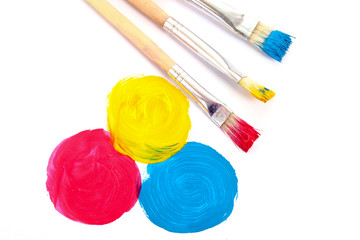 Three basic colours of painting and brushes isolated on white
