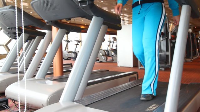 legs of woman exercising in gym