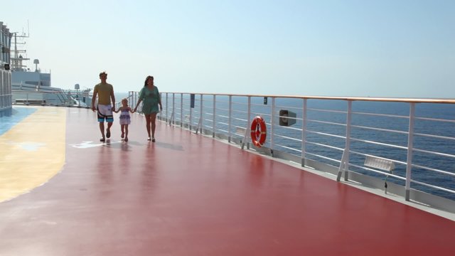 family is going to camera on deck of ship