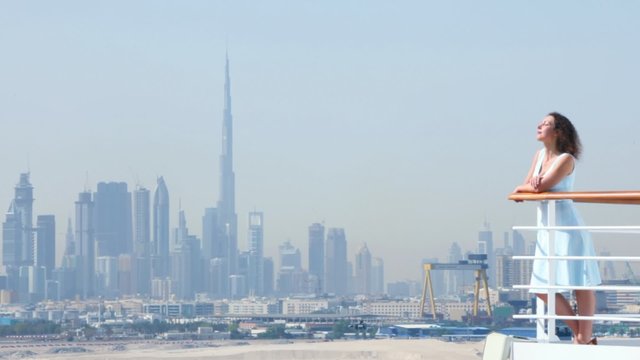woman is standing on the deck at railing in Dubai