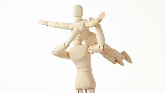 rotating wooden figures parent holding his child on hands