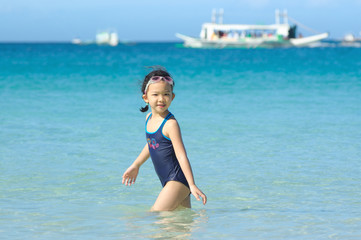 Asian kid playing on the beach