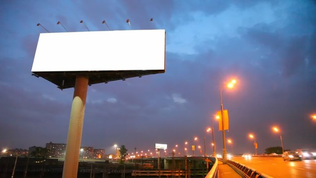 night bridge in city with moving cars and empty billboard