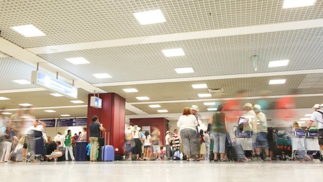 People with luggage in airport.