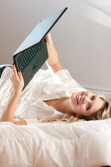 Beautiful woman on bed with laptop