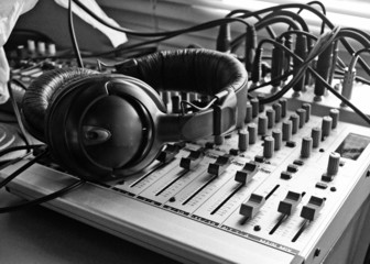 Into the mix in B&W showing a typical old style home recording set up with headphones 