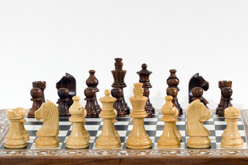 chess pieces and chess board on white