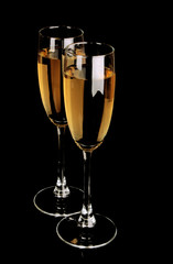 Glasses with champagne on black background