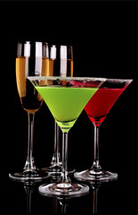 Martini glasses and champagne on black background