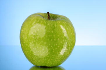 green apple on blue background