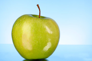 green apple on blue background