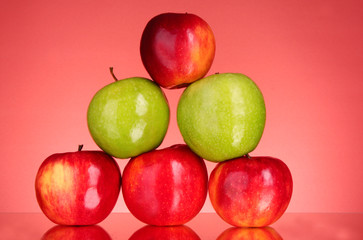 Apples on red background