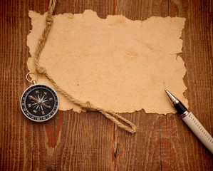 old paper, compass, pen and rope on grunge background