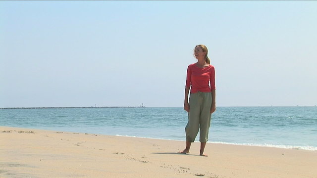 Young woman at shoreline of ocean