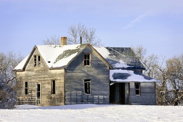 Old abandoned lonely farm house in Winter