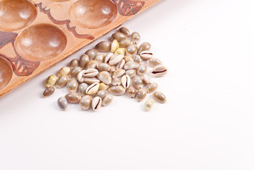 Mancala Game Shell Pieces with Board Background