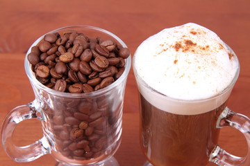 Glass of caffe latte with a glass of coffee beans