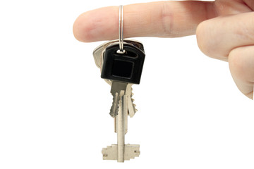 key in fingers isolated on a white background